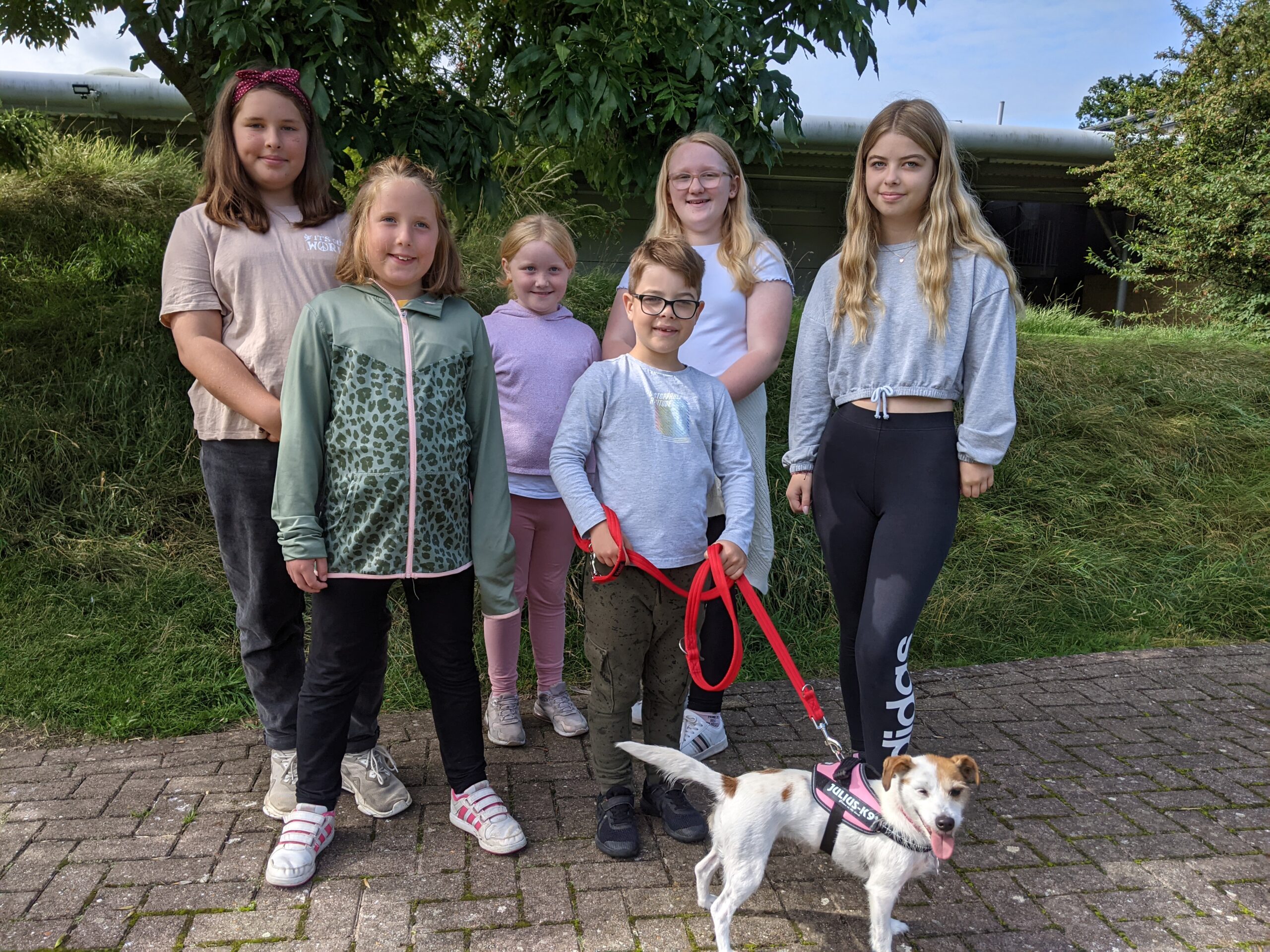Group of young people with a small white terrier during Animal Days
