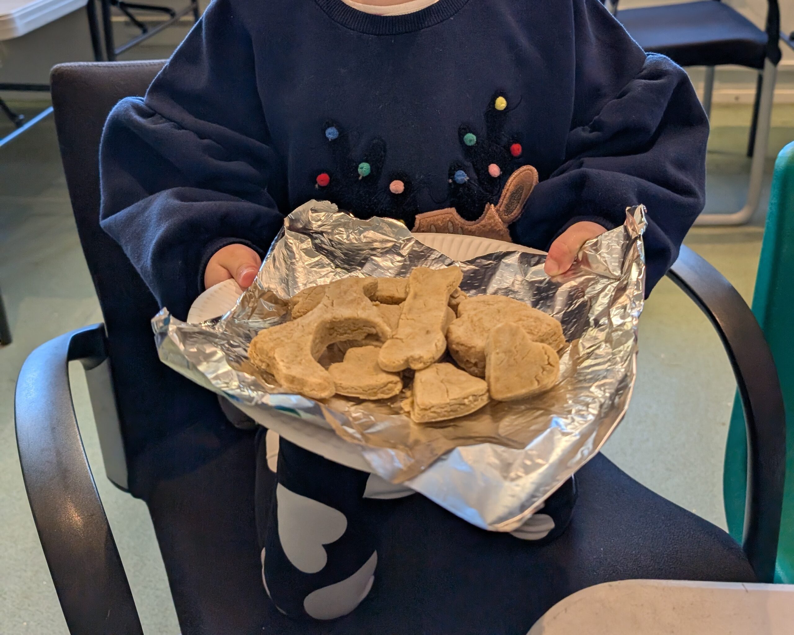 Young person with christmas dog biscuits at christmas crafts animal days session