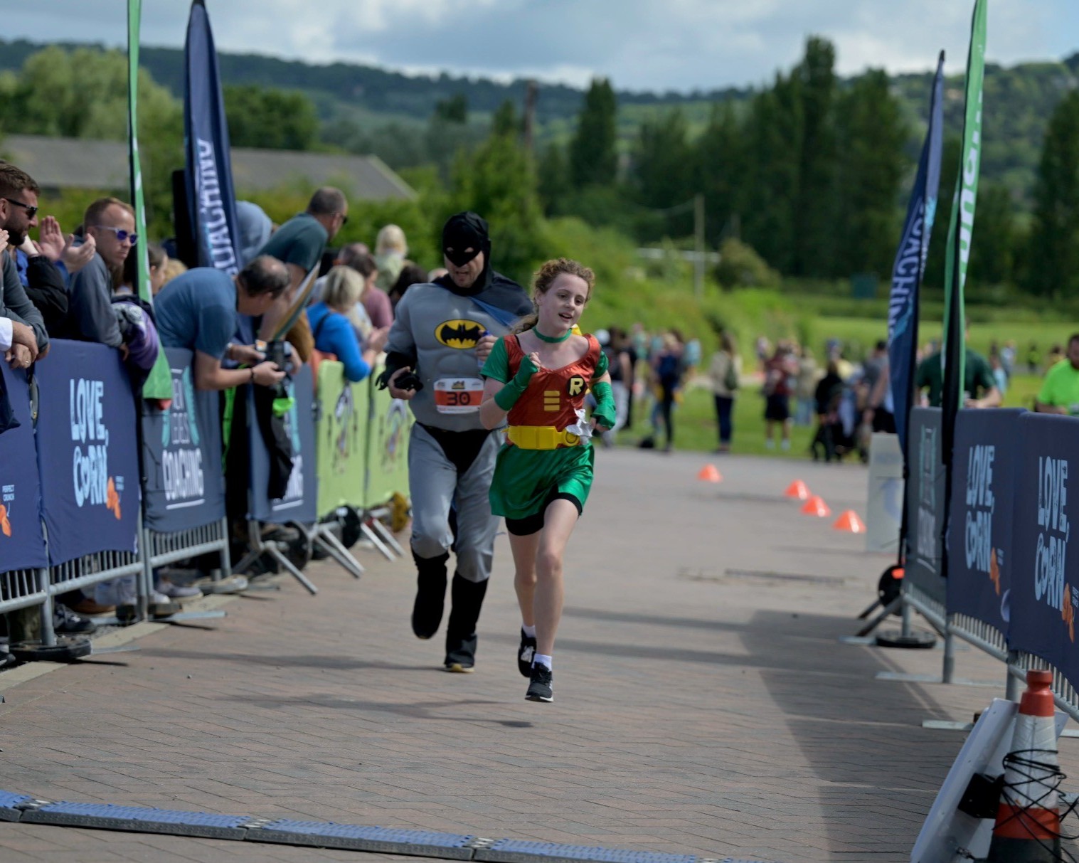 Father and daughter team dressed as Batman and Robin running in a charity race for the Shelter